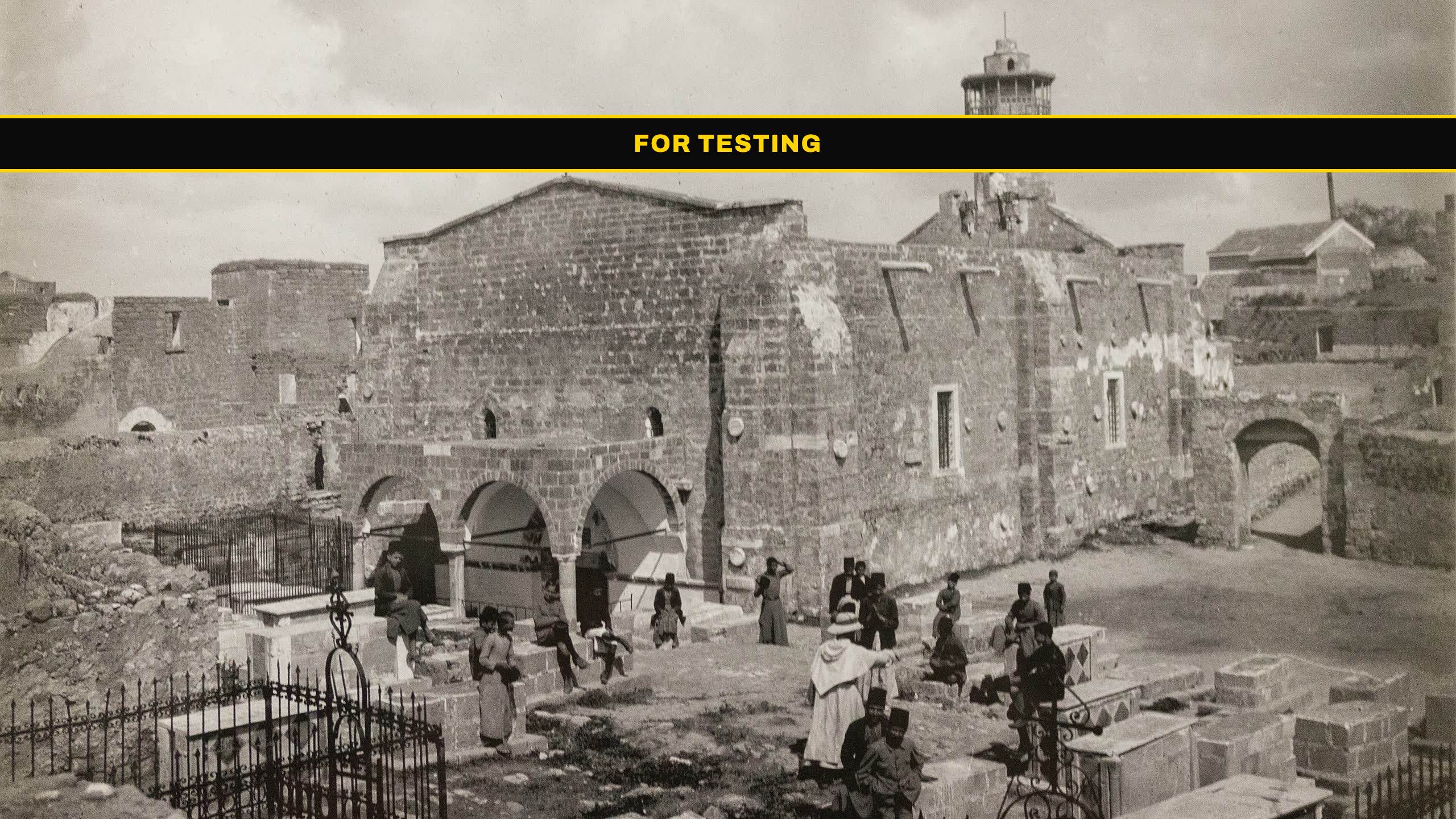 The Church of Saint Porphyrius in Gaza City, photographed in 1922: a stone church with a three-arched arcade along its southern side, a minaret rising behind it, and a walled burial ground in the foreground.